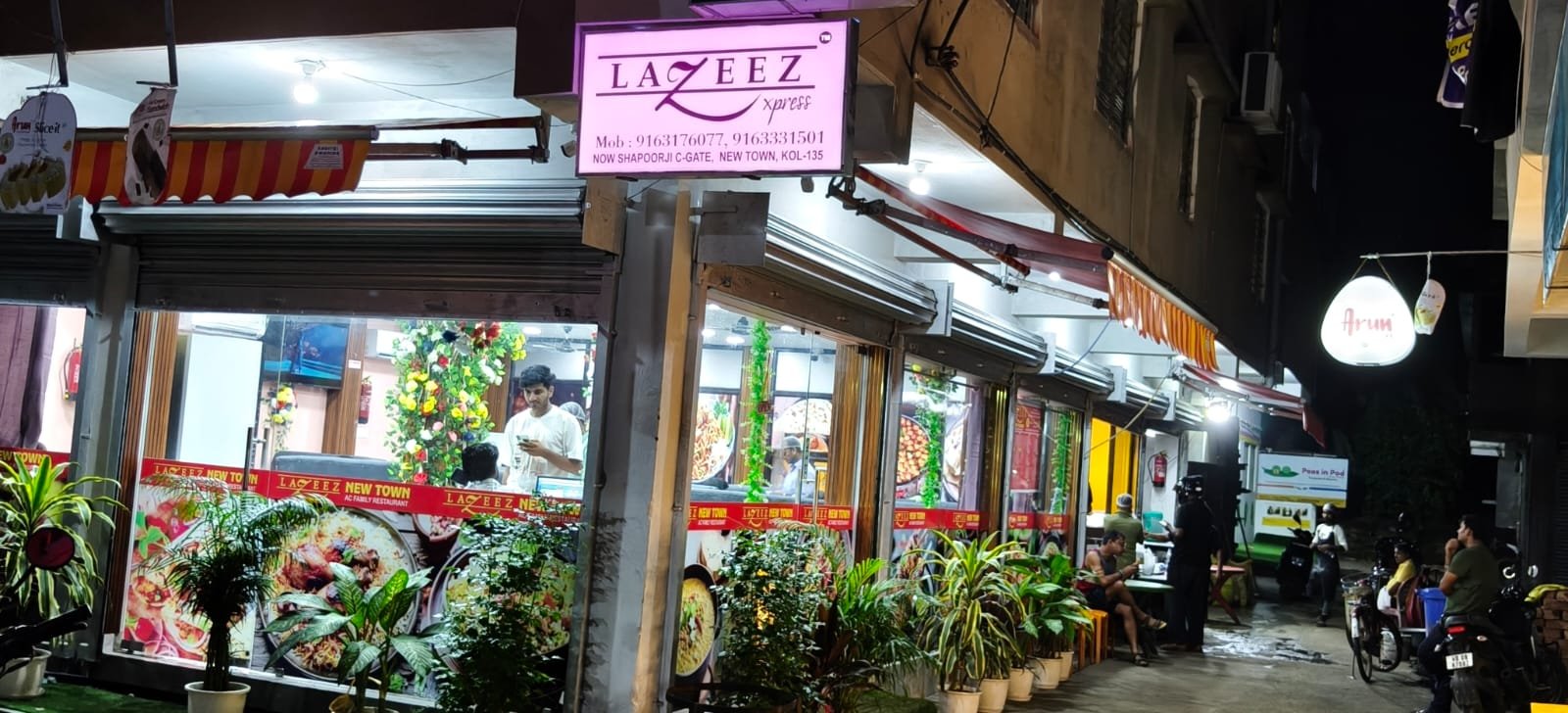 Lazeez NewTown seating area viewed through the storefront glass
